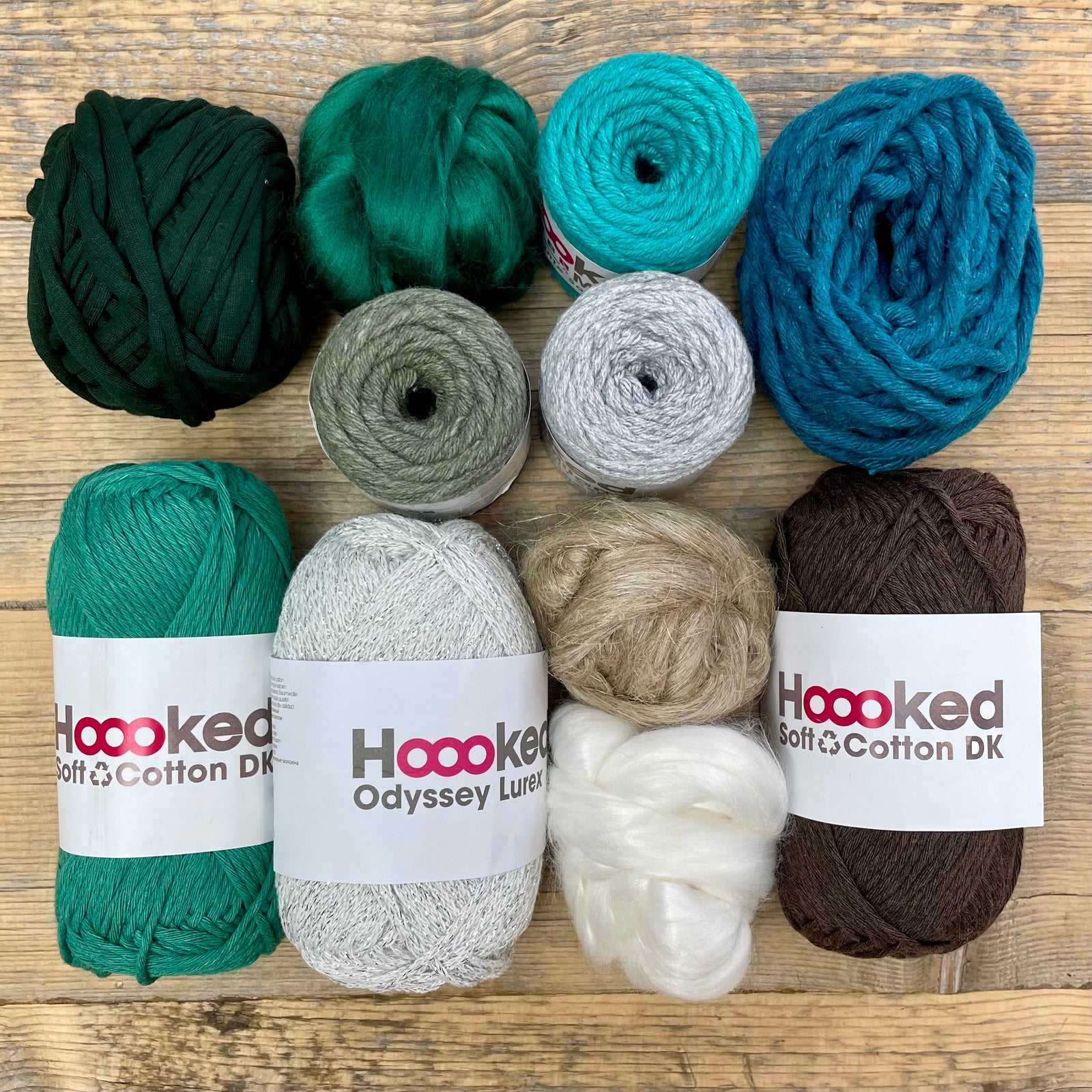 A multi-coloured yarn pack is displayed with an assortment of weaving yarn and fibre suitable as tapestry yarn, craft yarn, fiber art yarn and more. The colour way for these weaving supplies is 'Alpine'.