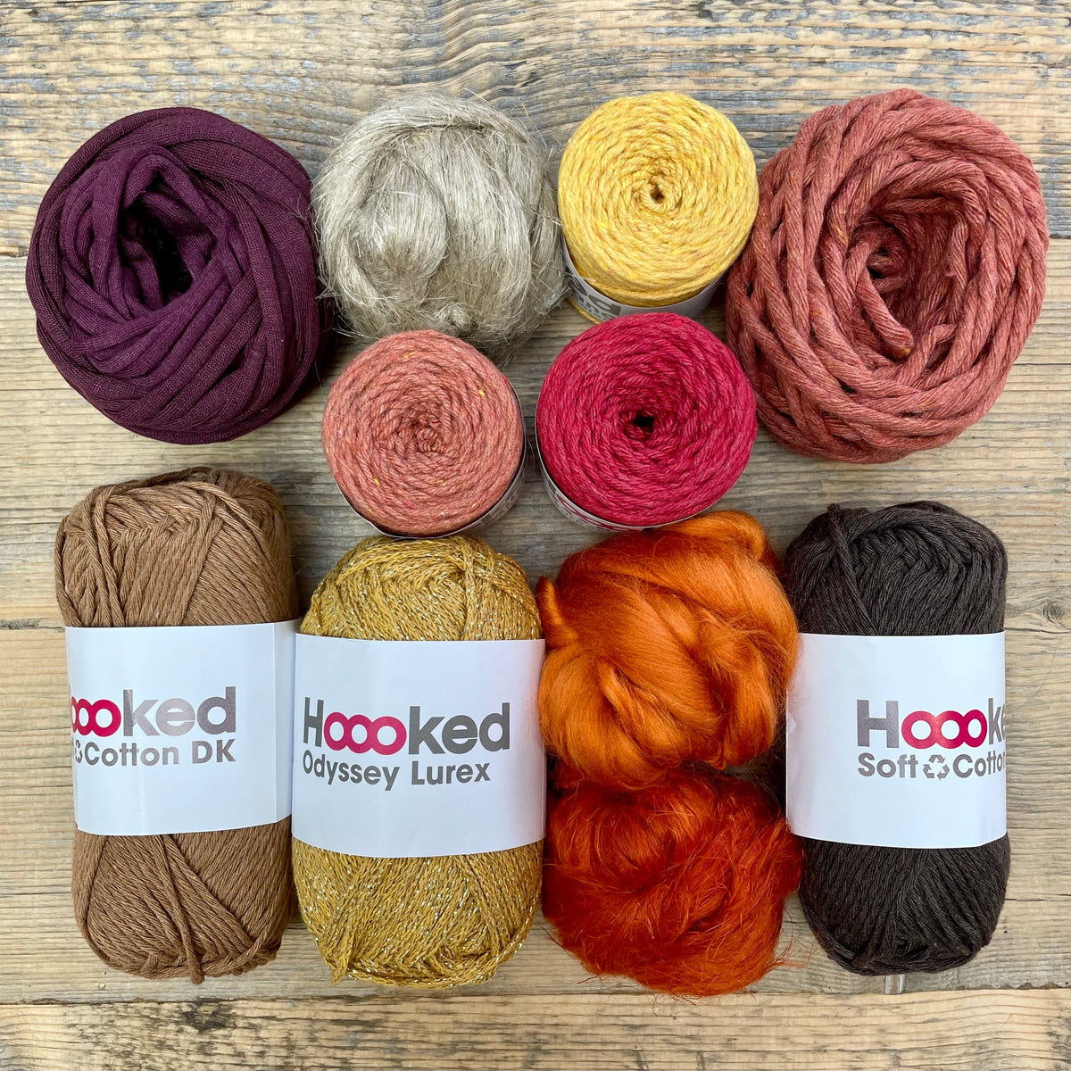 A multi-coloured yarn pack is displayed with an assortment of weaving yarn and fibre suitable as tapestry yarn, craft yarn, fiber art yarn and more. The colour way for these weaving supplies is 'Autumn'.