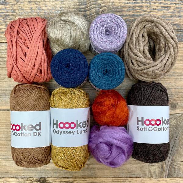 A multi-coloured yarn pack is displayed with an assortment of weaving yarn and fibre suitable as tapestry yarn, craft yarn, fiber art yarn and more. The colour way for these weaving supplies is 'Canyon'.