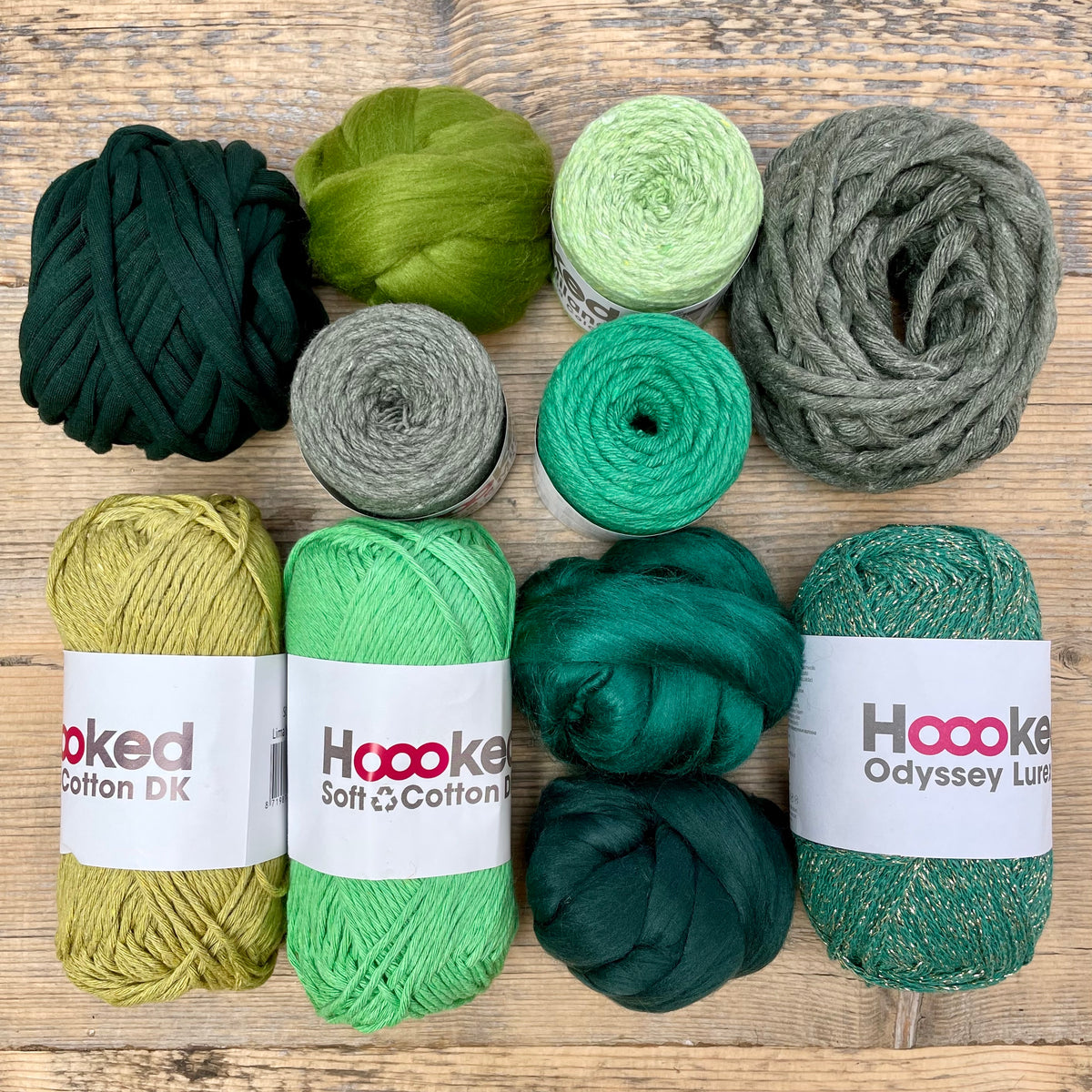 A multi-coloured yarn pack is displayed with an assortment of weaving yarn and fibre suitable as tapestry yarn, craft yarn, fiber art yarn and more. The colour way for these weaving supplies is 'Forest'.