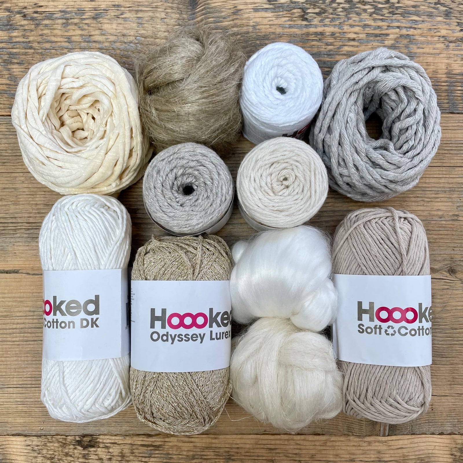 A multi-coloured yarn pack is displayed with an assortment of weaving yarn and fibre suitable as tapestry yarn, craft yarn, fiber art yarn and more. The colour way for these weaving supplies is 'Natural'.