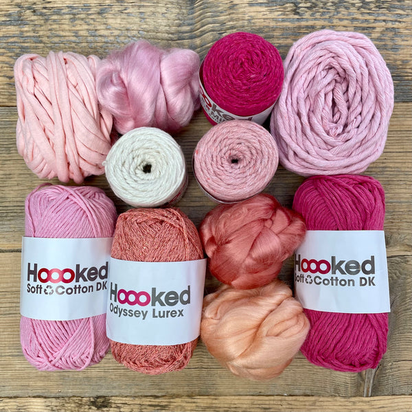 A multi-coloured yarn pack is displayed with an assortment of weaving yarn and fibre suitable as tapestry yarn, craft yarn, fiber art yarn and more. The colour way for these weaving supplies is 'Peach Melba'.