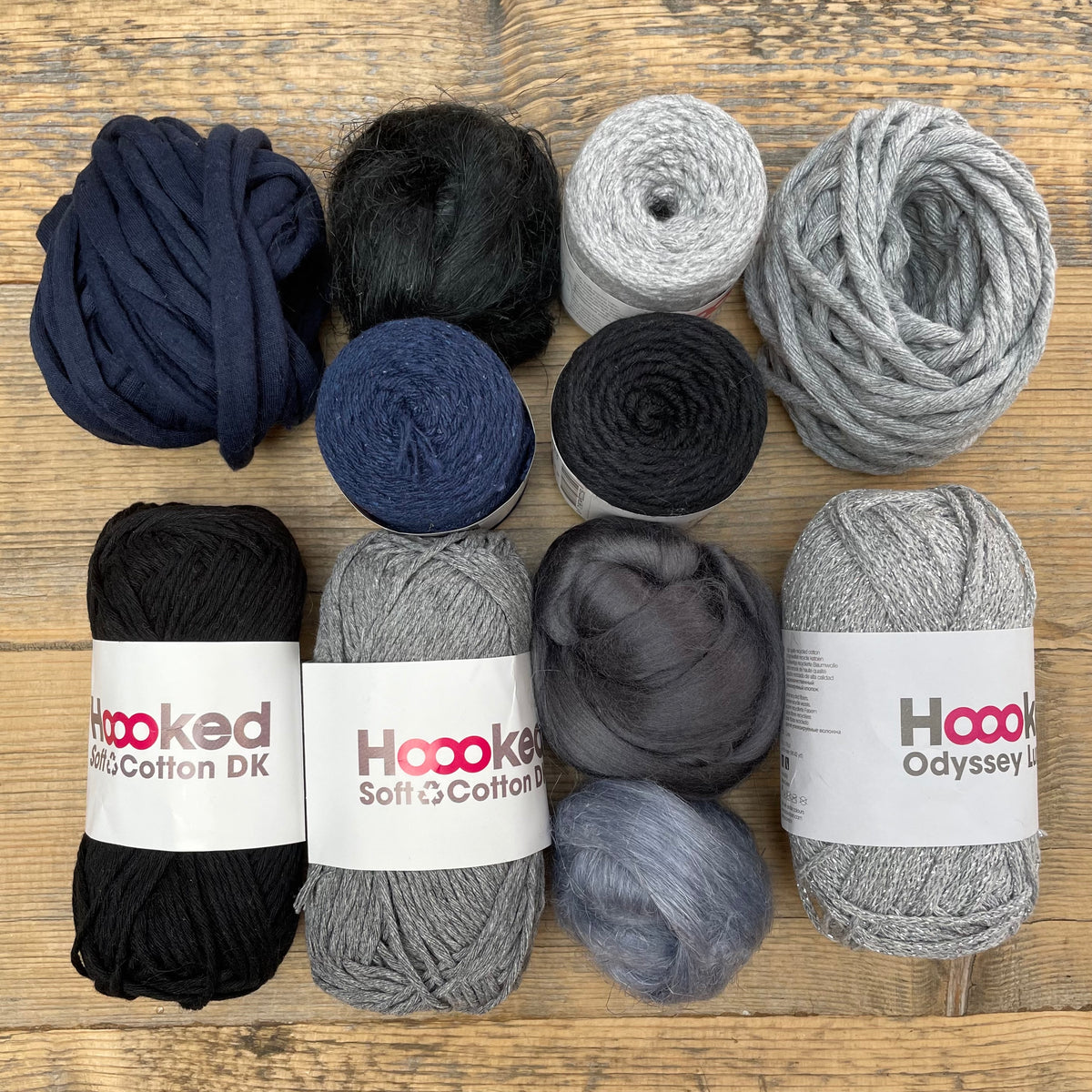 A multi-coloured yarn pack is displayed with an assortment of weaving yarn and fibre suitable as tapestry yarn, craft yarn, fiber art yarn and more. The colour way for these weaving supplies is 'Storm'.